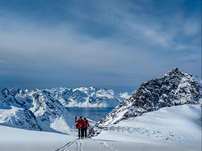 Ski tourers between sea and mountains in Greenland